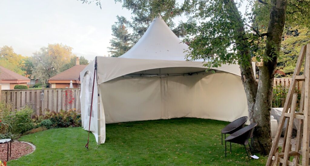 15x20 high peak marque tent with 3 sides on grass