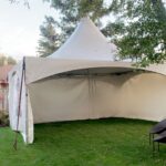 15x20 high peak marque tent with 3 sides on grass
