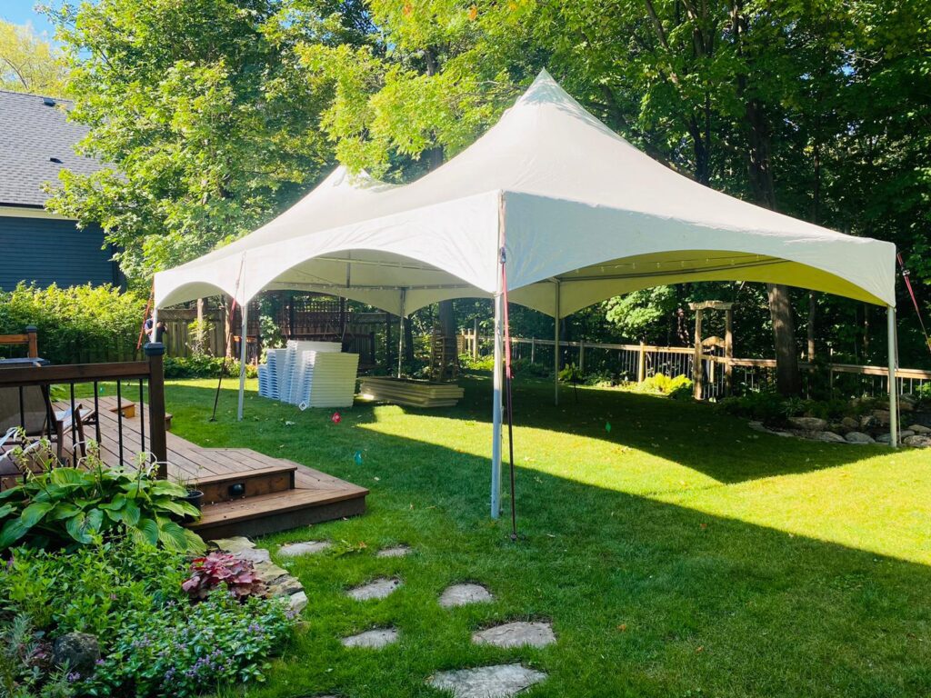 20x40 high peak marquee tent in a backyard
